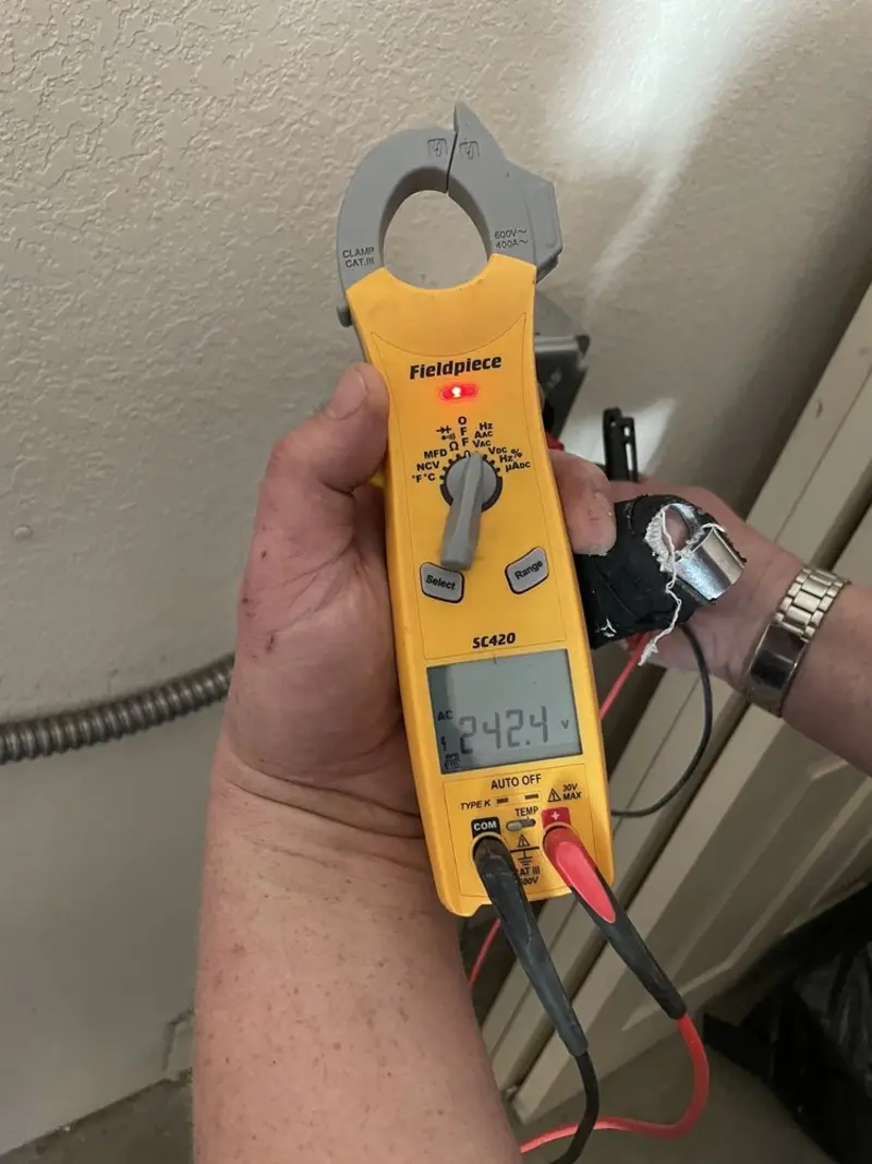 Voltage testing with clamp meter during Whole House Surge Protector in Triana